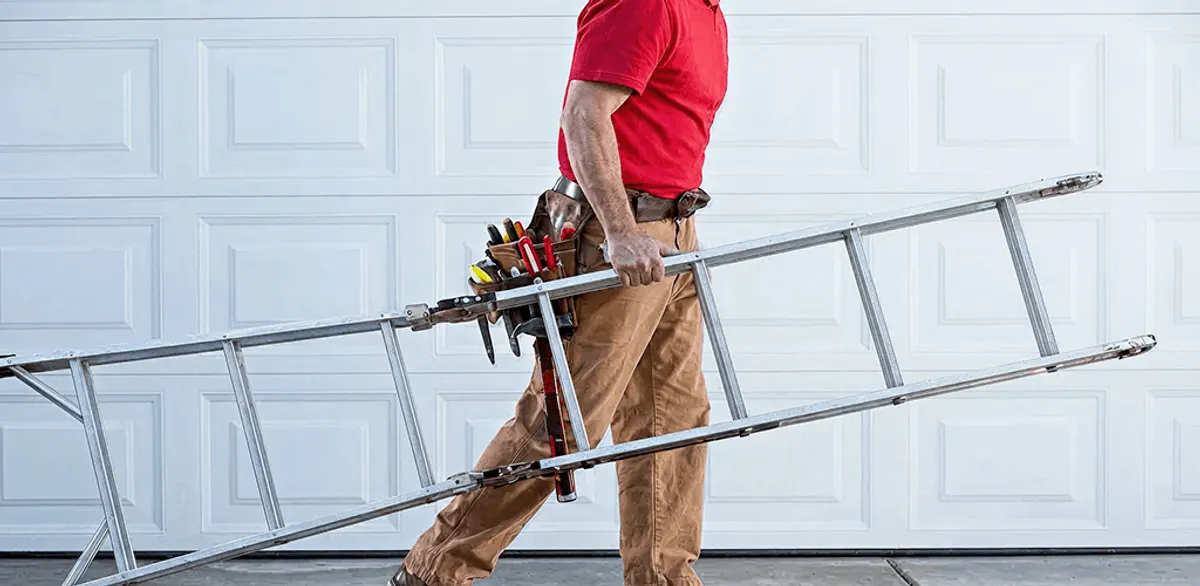 Garage door repair technician arriving with tools and ladder in Fargo, ND