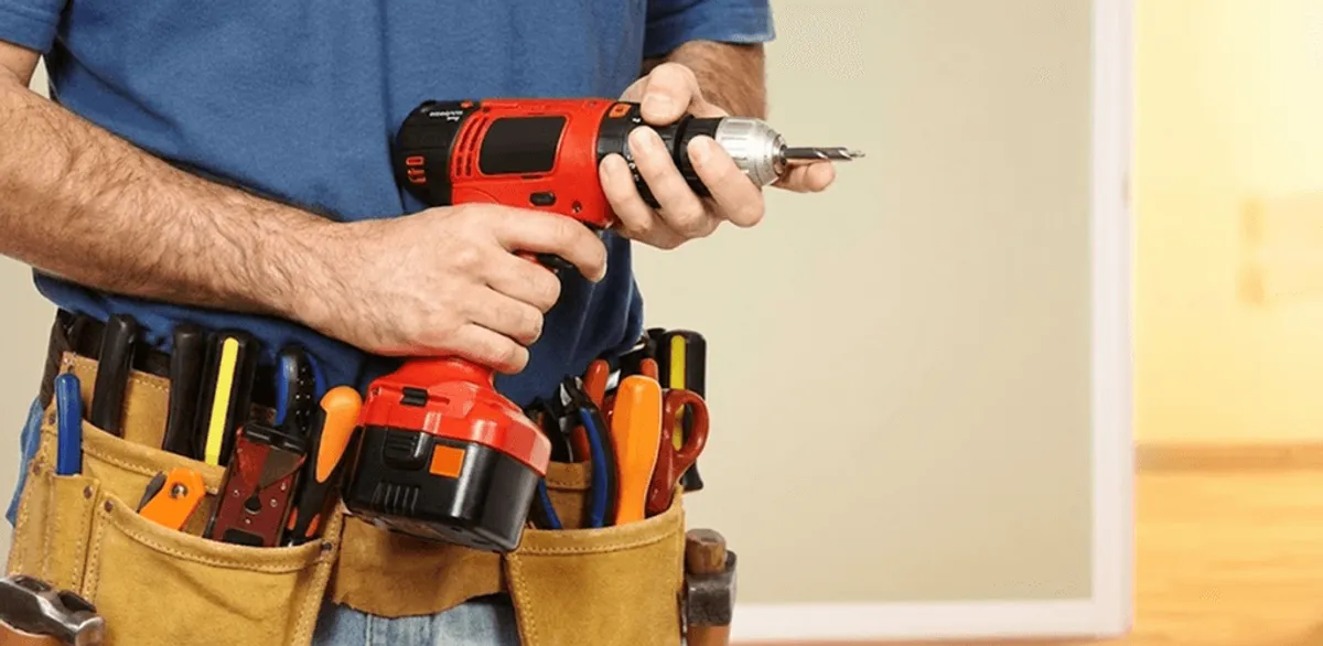 Handyman holding a power drill for home repairs and installations in Fargo, ND